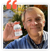 CitrusBurn customer holding up a bottle of CitrusBurn supplement outdoors